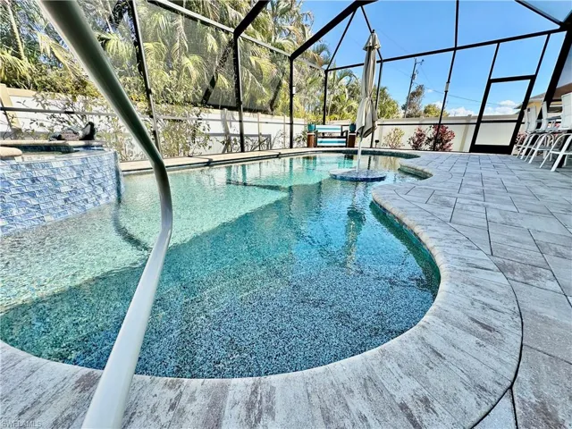 Outdoor pool with a sunroom, a lanai, a patio, and a jacuzzi