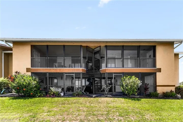 Rear view of property with a yard