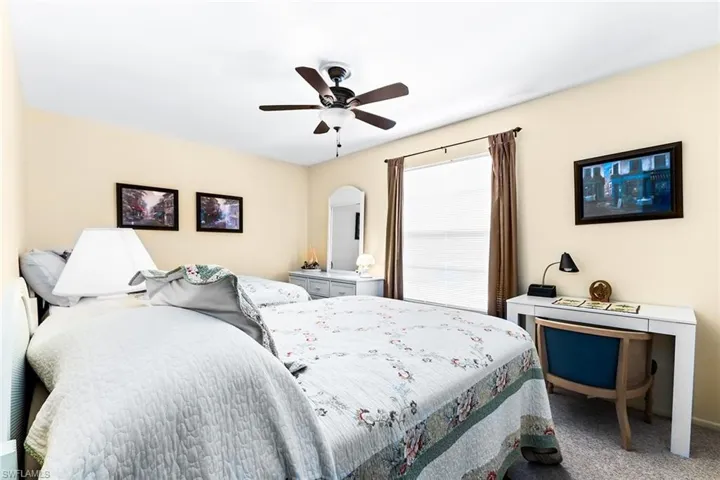 Bedroom with ceiling fan and carpet floors