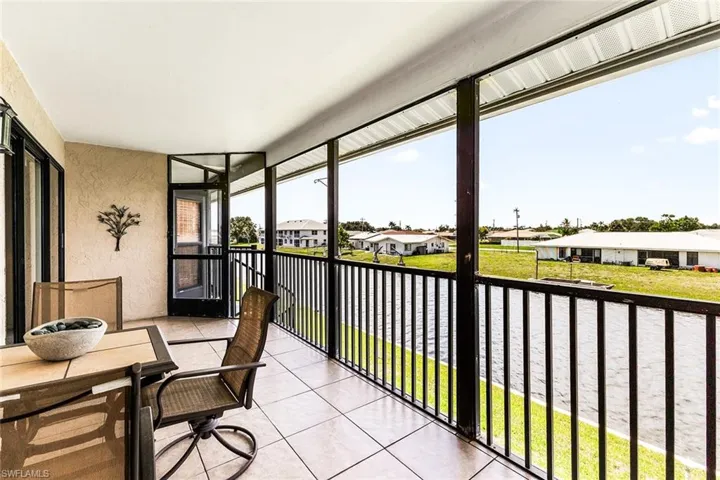 Sunroom / solarium with a water view and plenty of natural light