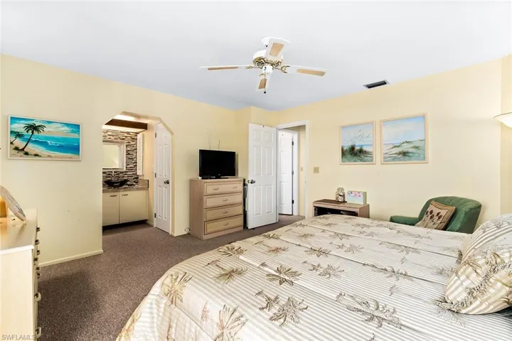 Carpeted bedroom with ceiling fan