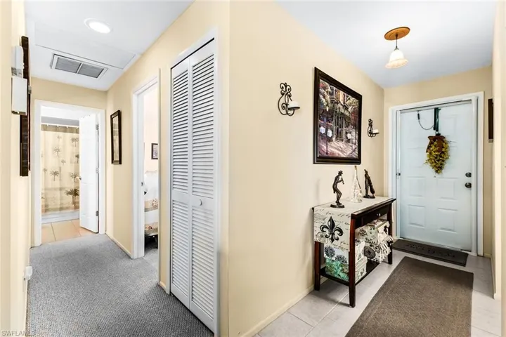 Entryway featuring light colored carpet