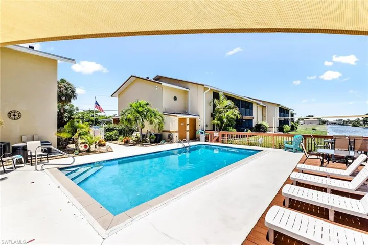View of swimming pool featuring a patio area and a water view