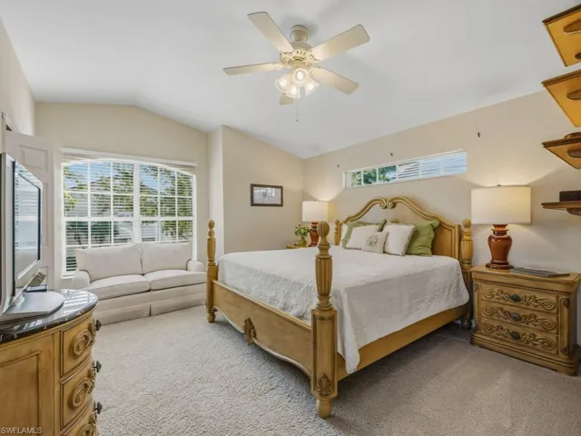 Bedroom featuring vaulted ceiling, carpet floors, and ceiling fan