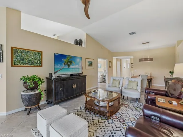 Living area featuring lofted ceiling and light tile patterned flooring
