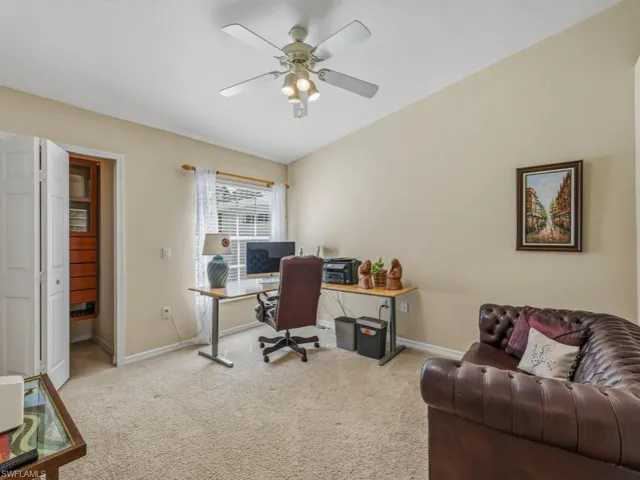 Bedroom featuring light carpet, a ceiling fan, and lofted ceiling