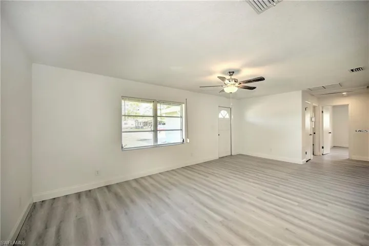 Empty room featuring ceiling fan and light hardwood / wood-style floors