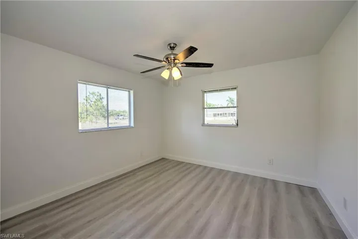 Spare room featuring light hardwood / wood-style flooring, plenty of natural light, and ceiling fan