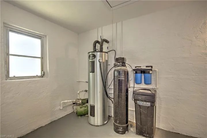 Utility room featuring electric water heater
