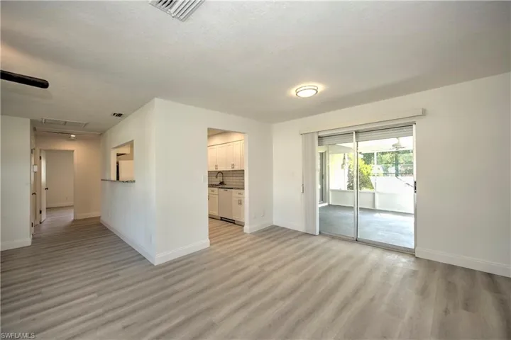 Unfurnished room with sink, a textured ceiling, and light wood-type flooring