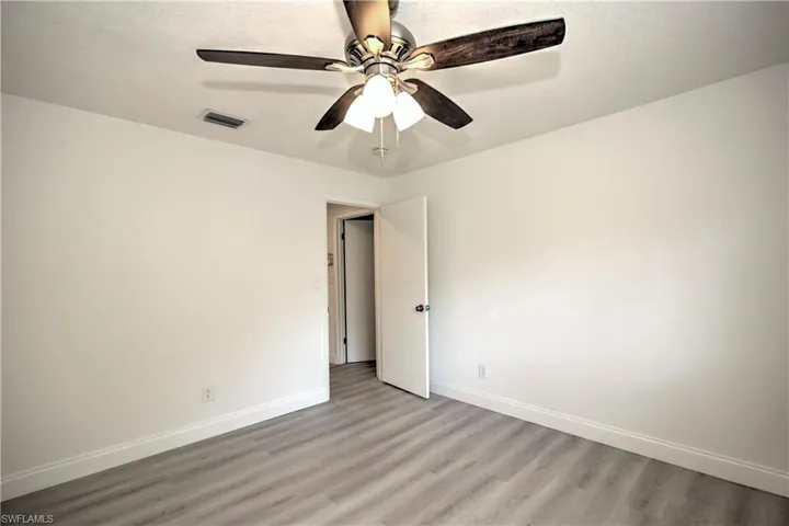 Spare room with ceiling fan and light hardwood / wood-style floors
