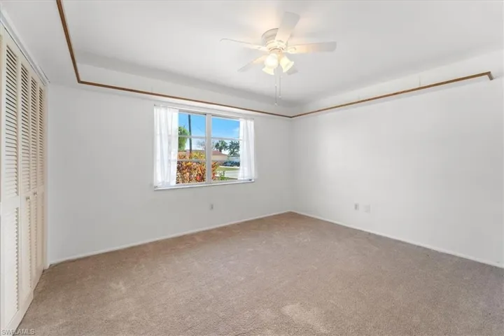 Unfurnished bedroom featuring a closet, ceiling fan, and carpet