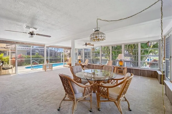 Sunroom featuring ceiling fan