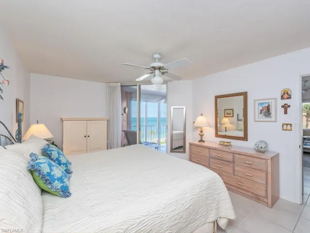 Bedroom with access to outside, a water view, ceiling fan, and light tile floors