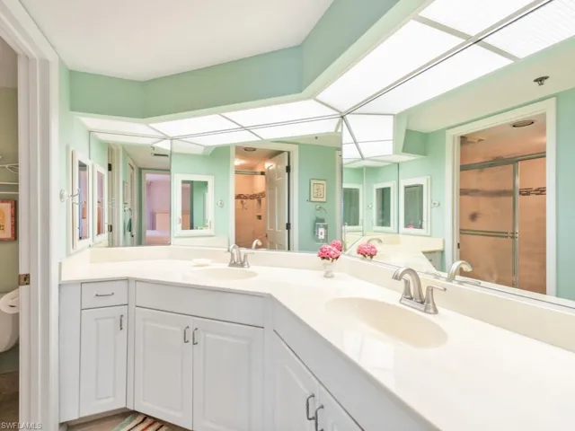 Bathroom featuring double sink and vanity with extensive cabinet space