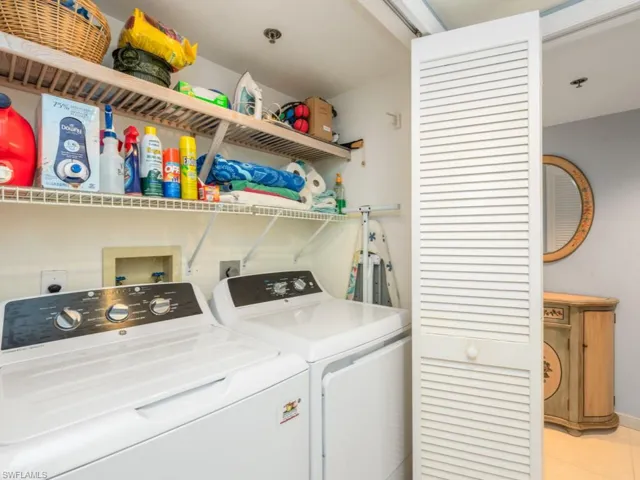 Clothes washing area with hookup for a washing machine, washing machine and clothes dryer, hookup for an electric dryer, and light tile floors