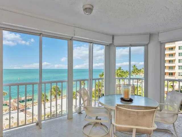 Sunroom featuring a water view