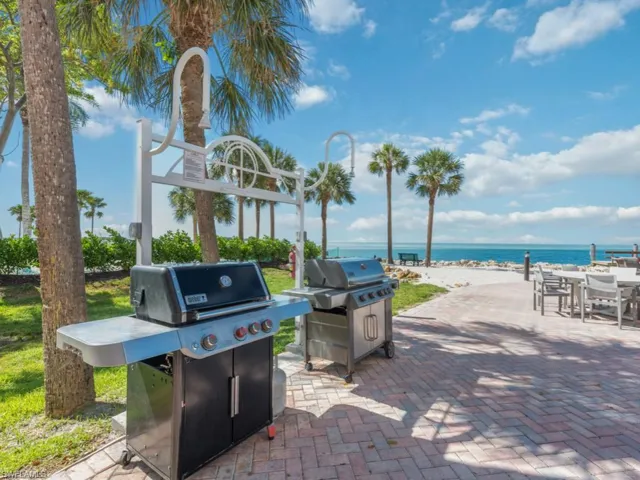 View of patio featuring a water view and a grill