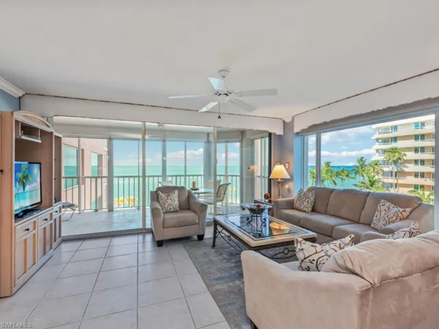 Tiled living room featuring ceiling fan