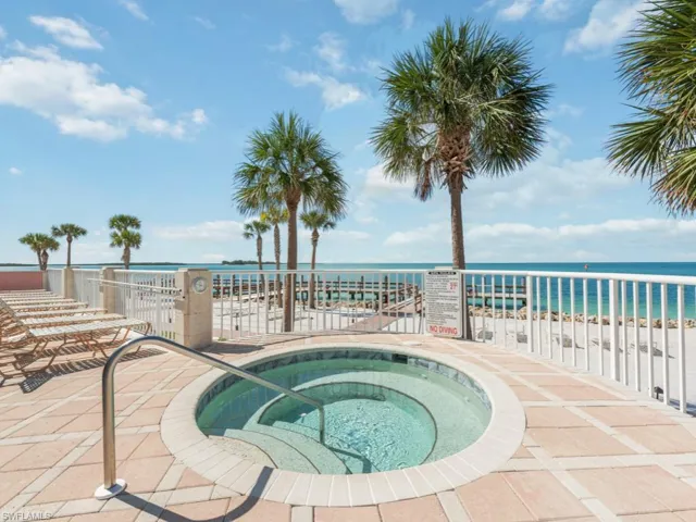 View of swimming pool with a community hot tub and a water view