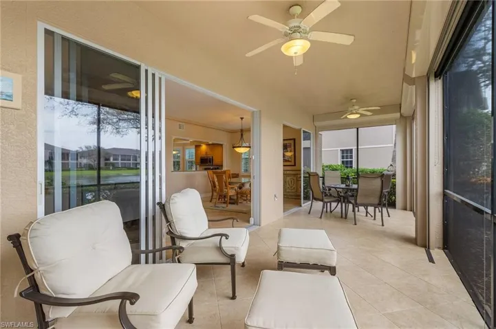 Sunroom / solarium with outdoor dining area, a ceiling fan, and a patio