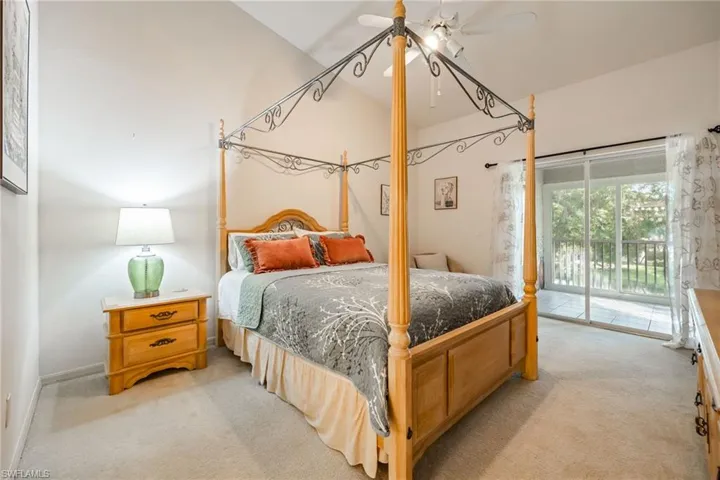 Bedroom featuring light colored carpet, access to outside, and ceiling fan