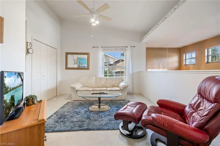 Den/extra bedroom featuring carpet flooring and a ceiling fan