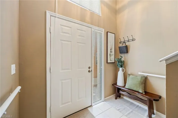 Tiled entrance foyer with baseboards