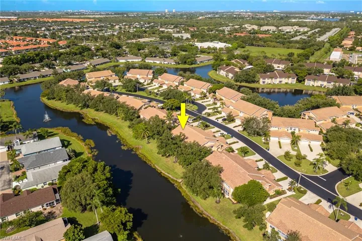 Aerial view of property and surrounding area with nearby suburban area and a nearby body of water