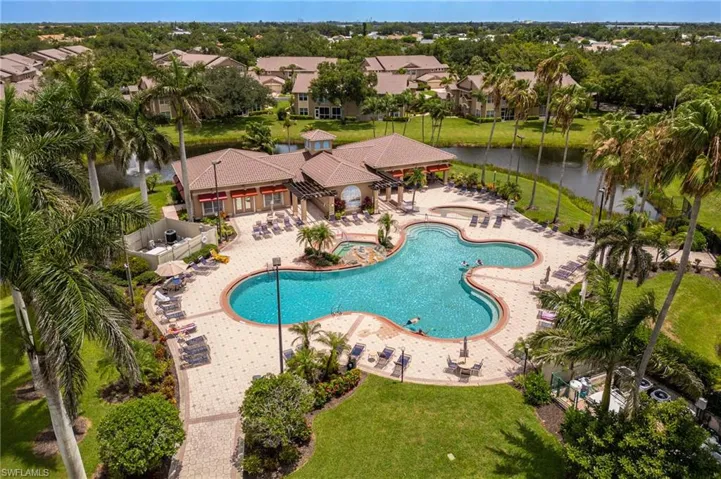 Community pool with a patio, a water view, and a residential view