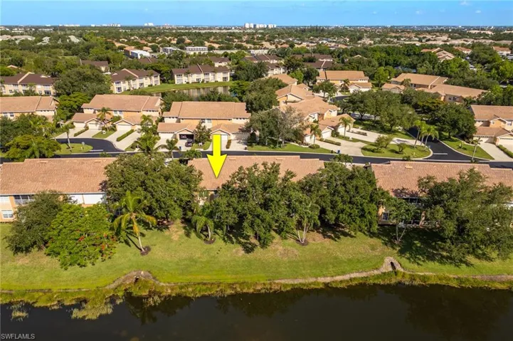 Aerial view of residential area featuring a large body of water