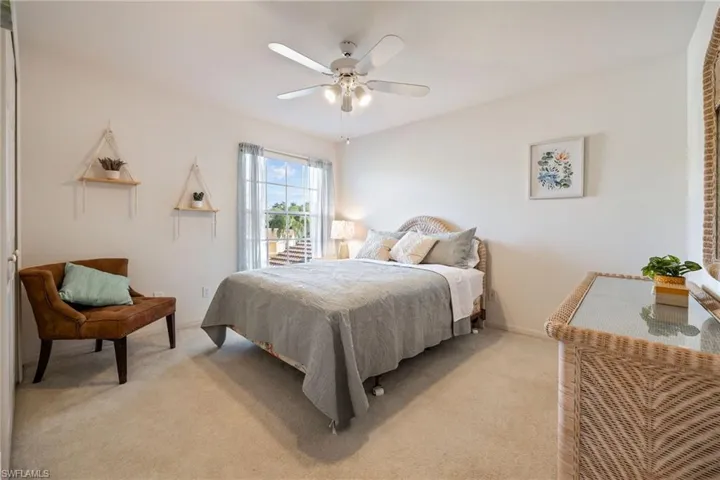 Bedroom featuring light colored carpet and ceiling fan