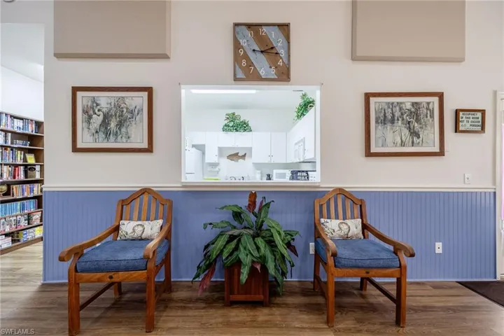 Community living area featuring a wainscoted wall, wood finished floors, and built in features