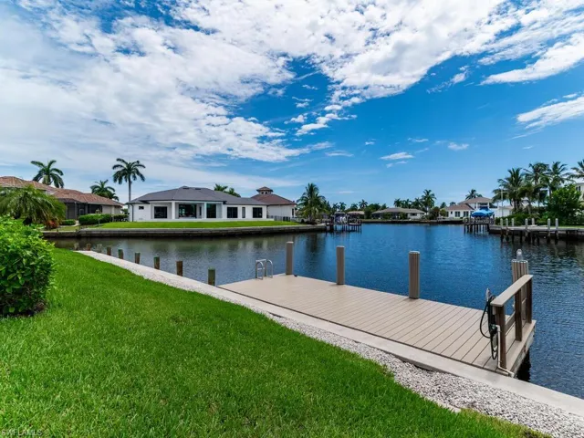 View of dock featuring a yard and a water view