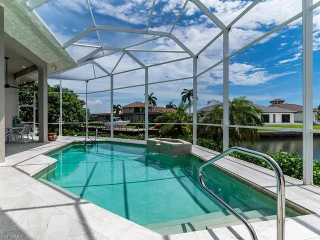 View of swimming pool featuring an in ground hot tub, a lanai, and a patio area