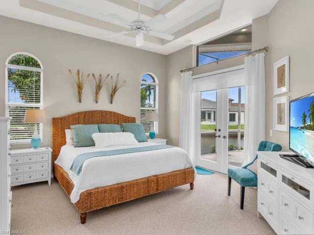 Carpeted bedroom featuring a high ceiling, french doors, access to outside, and ceiling fan