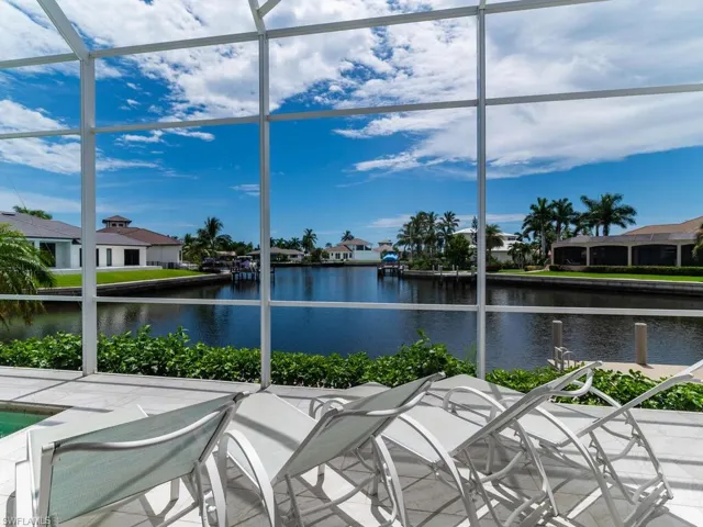 Sunroom featuring a water view