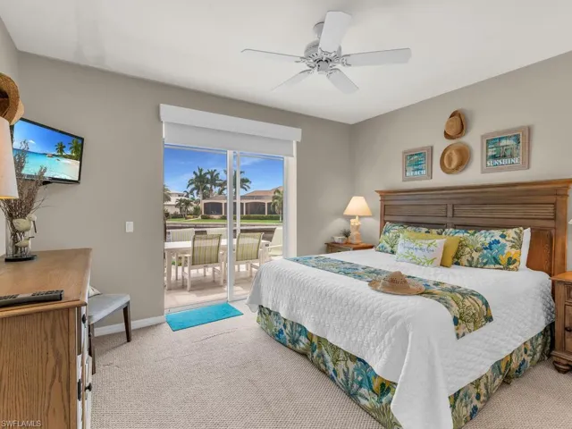 Bedroom featuring carpet floors, access to exterior, and ceiling fan
