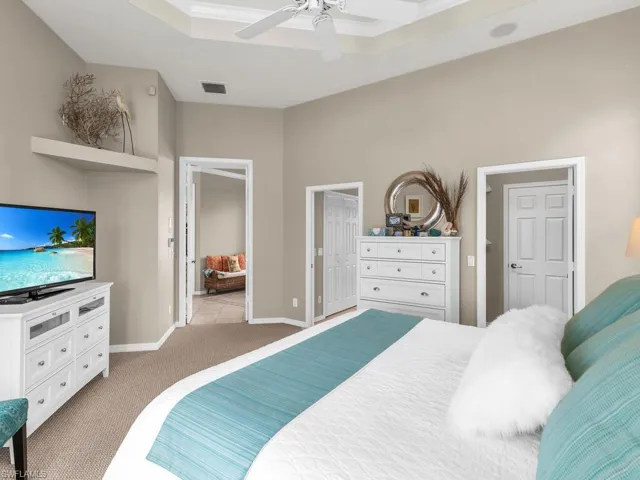Carpeted bedroom with ceiling fan