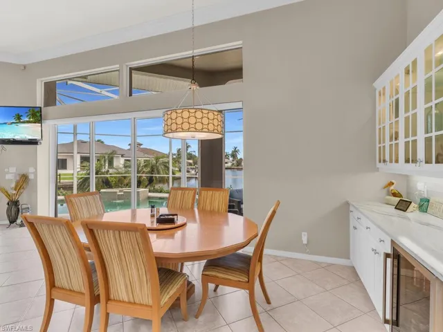 Tiled dining room featuring wine cooler