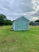 View of outbuilding featuring a yard