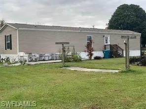 Back of property with a lawn