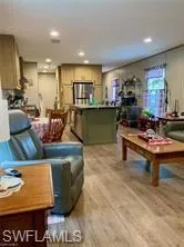 Living room with light hardwood / wood-style flooring