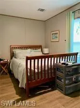 Bedroom with wood-type flooring