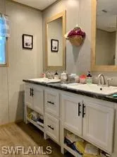 Bathroom with vanity and hardwood / wood-style flooring
