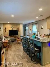 Kitchen featuring light hardwood / wood-style flooring and a breakfast bar