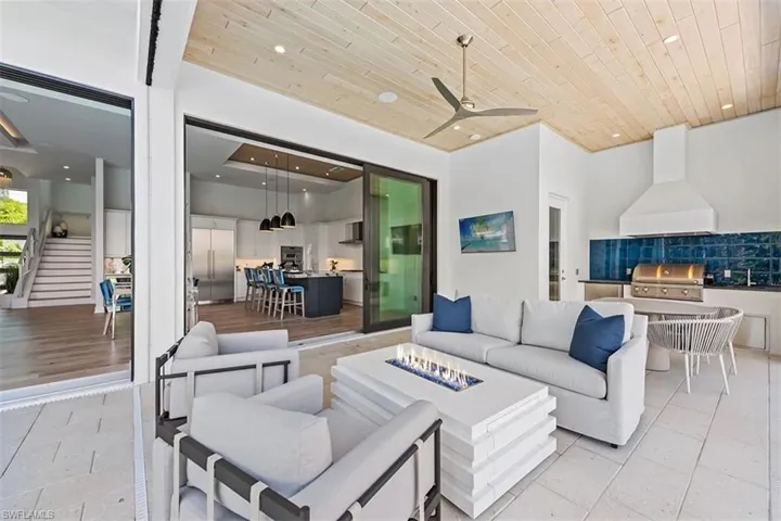 Living area featuring wood ceiling, a ceiling fan, recessed lighting, and light tile patterned floors