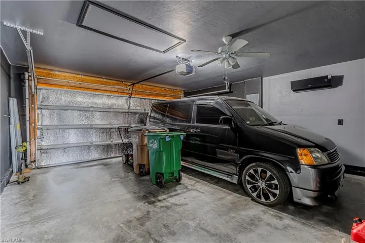 FULLY INSULATED AND AIR CONDITIONED GARAGE with a ceiling fan and a garage door opener