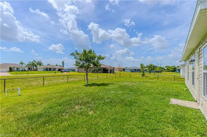 FULLY FENCED IN YARD, View of yard with a residential view
