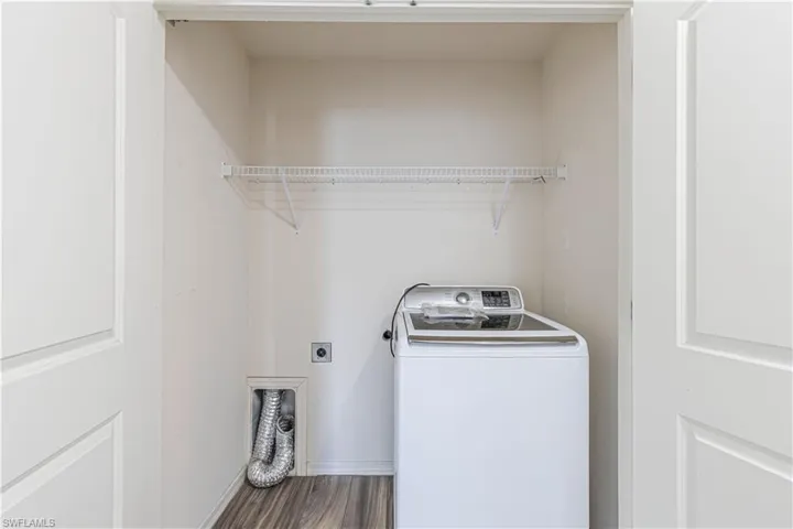 WASHER INCLUDED, Laundry area with washer / clothes dryer and dark wood-type flooring